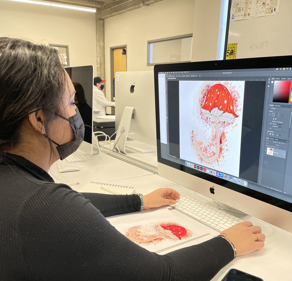 Student working on a mushroom design on the computer.